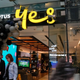 Customers walk out of an Optus telecommunications retail store in the central business district of Sydney, Australia.